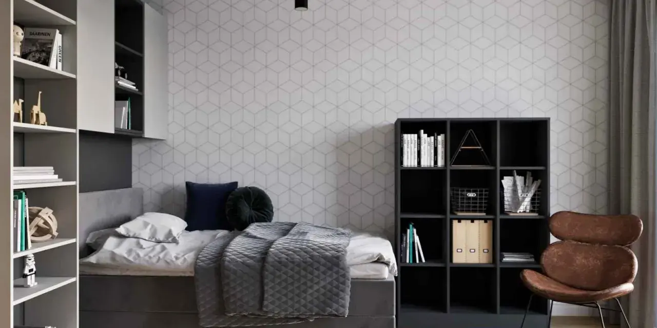 Nowoczesny pokój młodzieżowy dla dziewczyny: inspiracje. Szara tapeta w geometryczne wzory, wygodne łóżko, regały z książkami i stylowy fotel.