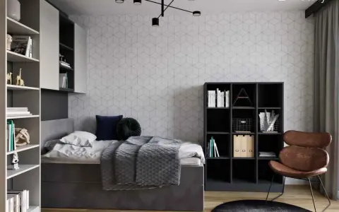 Nowoczesny pokój młodzieżowy dla dziewczyny: inspiracje. Szara tapeta w geometryczne wzory, wygodne łóżko, regały z książkami i stylowy fotel.