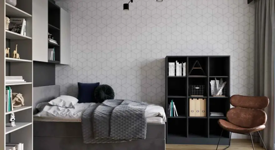 Nowoczesny pokój młodzieżowy dla dziewczyny: inspiracje. Szara tapeta w geometryczne wzory, wygodne łóżko, regały z książkami i stylowy fotel.